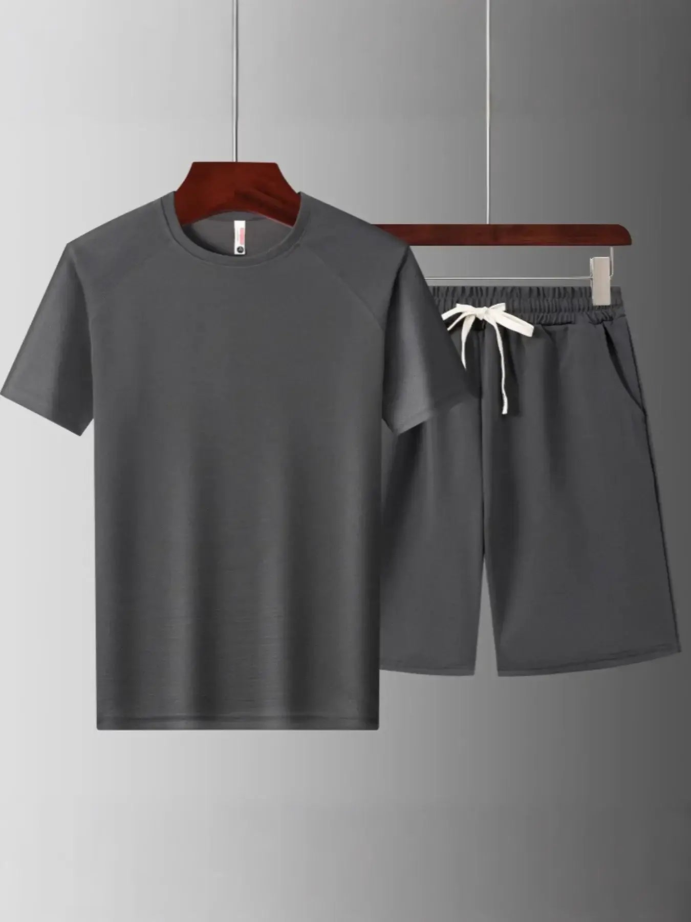 Men's plus size short sleeve top and shorts set in dark gray with drawstring and pocket detail.